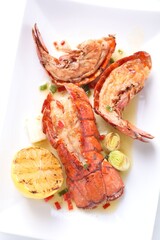 Sticker - Delicious lobster tails with lemon and green onion on white table, top view