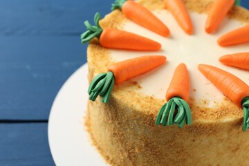 Wall Mural - Delicious homemade carrot cake on blue table, closeup