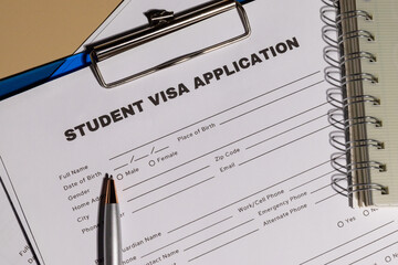 a neatly placed student visa application on a clipboard, illustrating the legal paperwork required f