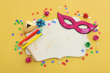 Wall Mural - Purim celebration concept (jewish carnival holiday) over yellow background