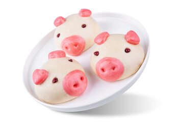 Steamed buns with custard filling in the form of pig in a plate on a white isolated background