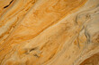 © JoseLuis - Natural texture background of sandstone rocks with lines, curves, prints in the As Amoeiras and Formosa beach cliffs in Santa Cruz, Portugal.