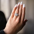 © Vladyslav - Close-up of a woman's hand displaying an elegant ring in a softly lit indoor setting