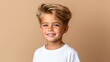 © Oleksandr - Smiling young boy showing healthy looking directly at the camera with a side part hairstyle. Isolated on a beige background.