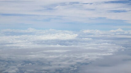 Wall Mural - blue sky with white fluffy clouds from airplane flight fly over the clouds in a sunny day with cloud moving in the atmosphere in hot weather summer time.