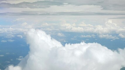 Wall Mural - blue sky with white fluffy clouds from airplane flight fly over the clouds in a sunny day with cloud moving in the atmosphere in hot weather summer time.