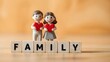 © IDrealdesigns - Family concept with miniature couple holding red hearts, wooden blocks spelling family, warm domestic scene for relationship and love