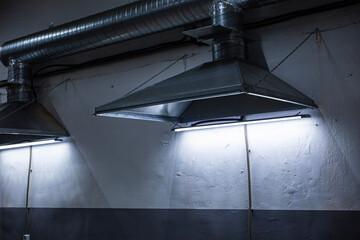 close-up of exhaust hoods in hazardous production, together with an air removal system, photographed immediately after installation work