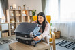 © Miljan Živković - One woman pack suitcase baggage prepare for vacation holiday