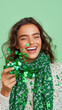 © Ruzana - Joyful celebration with green confetti and smiling model, perfect for st patrick's day design
