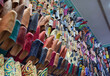 © CarlosMSubirats - Side view Slippers or sandals of many colors hung from street stalls in Marrakech's souk