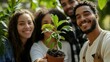 © Tanya - Cropped shot of a team of colleagues holding a plant growing out of soil ecology