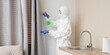 © Pixel-Shot - Female worker of cleaning service removing mold from curtain in kitchen