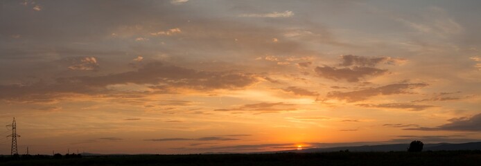 Wall Mural - Sunset over the Balkans. The stillness and the dusk. Cirrus clouds in a crimson sky.