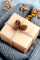 Wall Mural - brown box with pine cones on top of it. the pine cones are tied to the box with string. the box is s
