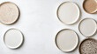 © siraphol - Neutral colored ceramic plates arranged on textured background