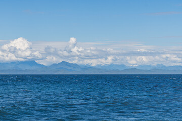 Wall Mural - panorama view from the shore of Malcolm Island beautiful water of the ocean with clouds on blue sky