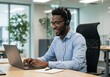 © ferifadli - A young African American man working happily in his office