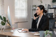 © David - Cheerful business Asian woman making telephone call share good news about project working in office workplace, business finance concept.