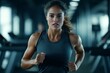 © Atmospheric stock - Focused young caucasian female running in modern gym environment