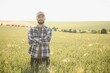 © Serhii - Portrait of farmer standing in wheat field