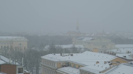 Wall Mural - view of the roofs of winter St. Petersburg from above during a snowstorm