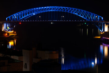 Wall Mural - illuminated bridge on the sea in the night