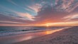 Sunset over calm ocean with colorful clouds reflecting on wet sandy beach and gentle waves lapping at the shore during twilight hours