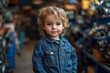 © c80 - Young child poses confidently in a workshop filled with tools and machinery