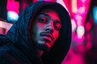 © c80 - Portrait of a young man in a vibrant urban setting with neon lights at night
