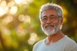 © c80 - Middle-aged man smiles warmly outdoors during golden hour in a lush garden setting
