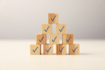 Wall Mural - Pyramid of wooden cubes with check marks on table