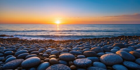 Poster - Tranquil Sunset Over Deep Blue Sea with Pebble Beach in Foreground and Ample Space for Text or Branding Elements