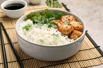 Wall Mural - Tasty rice with broccoli and chicken served on grey table, closeup