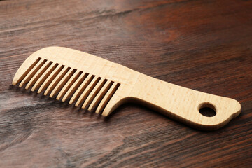 Wall Mural - One hair comb on wooden background, closeup