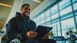© felix_brönnimann - Man in wheelchair using tablet at airport lounge, smiling while traveling, accessible technology, lifestyle, comfortable seating, modern travel experience.