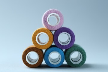 Wall Mural - Spools of colorful sewing threads on light background