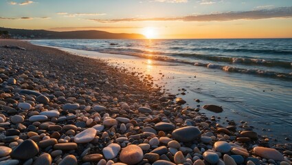 Poster - Pebbled beach at sunset with gentle waves and colorful sky reflecting on water and shoreline scenery in the background