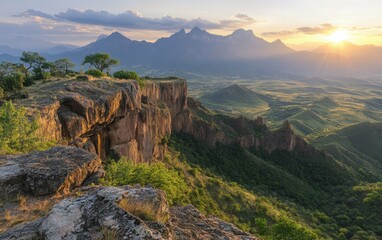 Wall Mural - Majestic mountains rise against a dramatic sunset, with a steep cliff offering breathtaking views of the vibrant sky and distant horizons.