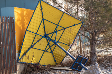 broken and discarded beach umbrella in winter