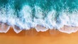 © DSimage - Aerial view of a serene beach featuring a gentle wave approaching the sandy shore, highlighting the beauty of nature's coastal landscape.