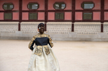 Back view Korean woman in colorful traditional Hanbok costumes walking in Gyeongbokgung Palace most popular tourist attraction in Seoul, South Korea