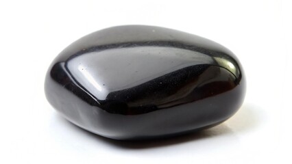 smooth and shiny black stone on a white background for creative and elegant design purposes