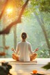 © Premium_art - Woman meditating peacefully in a lush garden, bathed in the warm glow of sunrise.
