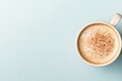 © Dack - Creamy coffee with sprinkle of cinnamon in minimalist cup on sof