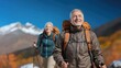 © Юлия Падина - Elderly caucasian couple hiking in mountains with backpacks and poles
