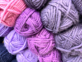 Colorful yarn balls forming a cozy pile for knitting and crochet