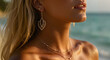 © bastet - Woman wearing elegant gold jewelry on the beach at sunset