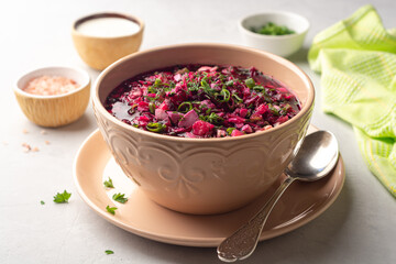 Wall Mural - Cold borscht or Holodnik or Svekolnik, traditional summer beet soup in ceramic bowl on concrete background