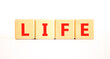 © Dzmitry - Life symbol. Concept word Life on beautiful wooden blocks. Beautiful white table white background. Business, lifestyle, support and life concept. Copy space.